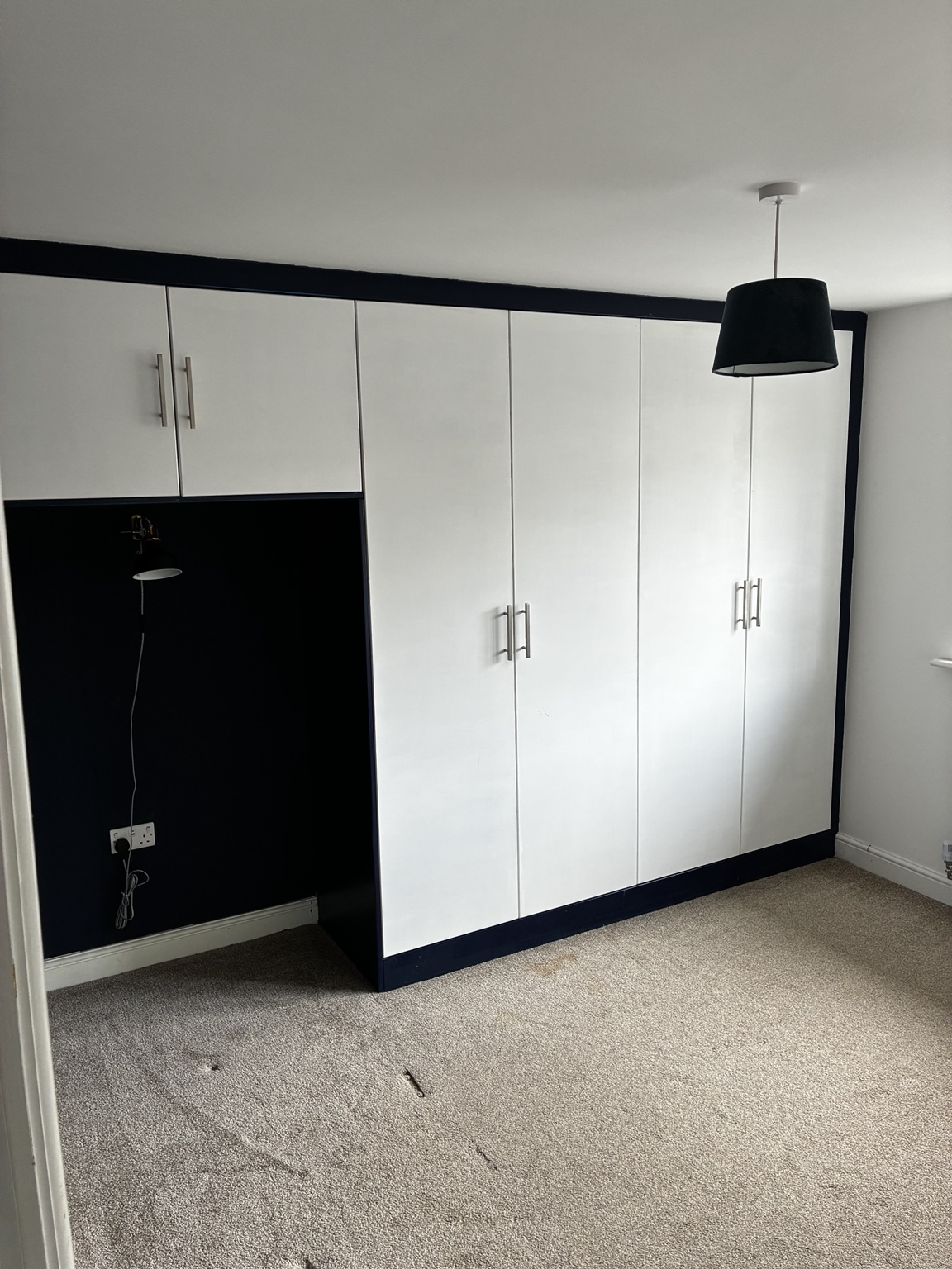 White fitted bedroom wardrobes with dark trim